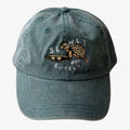 Blue cap with turtle design and text on a white background