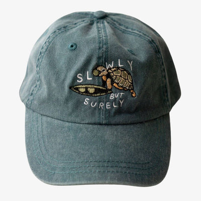 Blue cap with turtle design and text on a white background