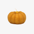A small, pumpkin-shaped beeswax candle. The candle is orange with detailed ridges and a wick in the center.