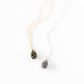 Necklace with pine cone pendants on a white background