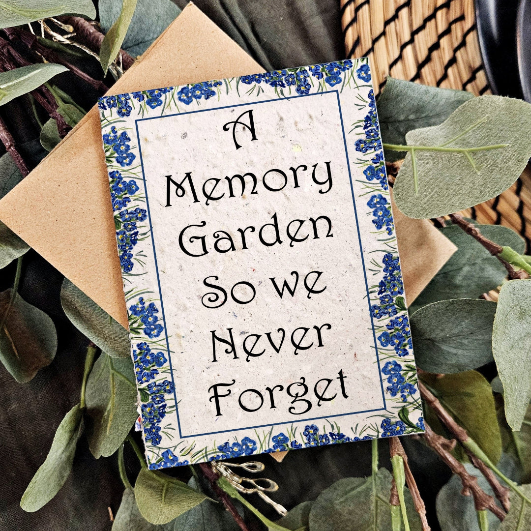 Decorative sign with text 'A Memory Garden So we Never Forget' surrounded by greenery