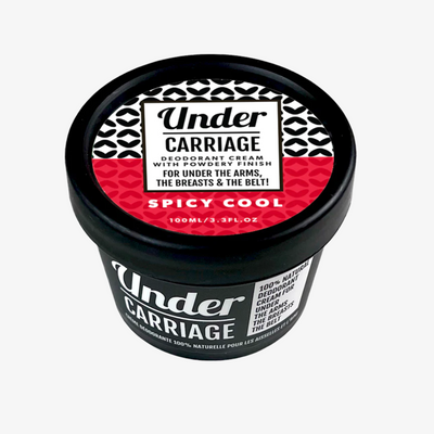A jar of Undercarriage Spicy Cool Natural Deodorant with a black lid and red and white label.