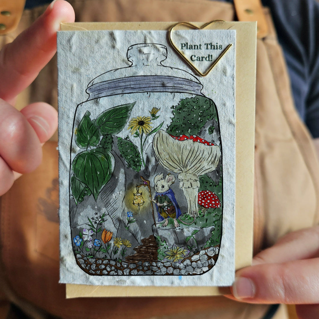 Card with a plantable design held by a person