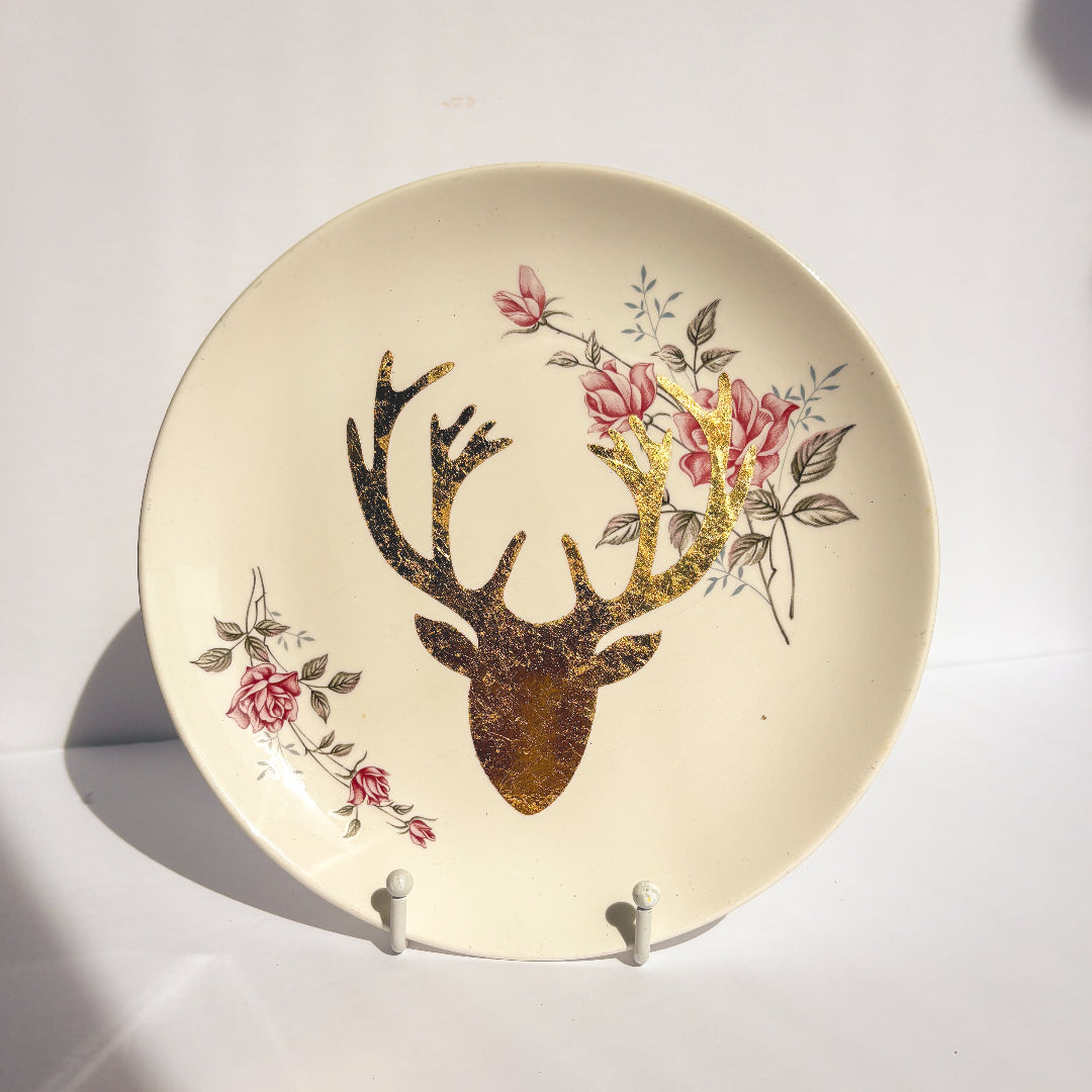 Decorative plate with a deer head and floral design on a white background