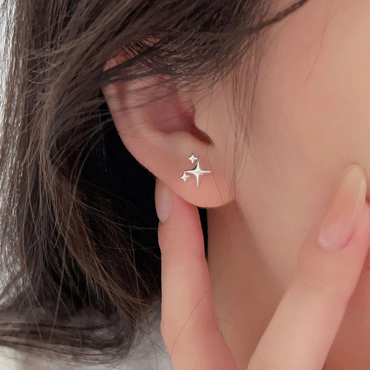 Shine bright like a diamond (or, you know, a star!) with our Star Emoji Cluster Studs | Sterling Silver! These adorable studs feature a cluster of tiny star emojis, perfect for adding a touch of playful charm to your look. Crafted in sterling silver, they're both stylish and durable. Lightweight and comfortable, they're perfect for everyday wear or a sweet gift for a friend. Reach for the stars! 
