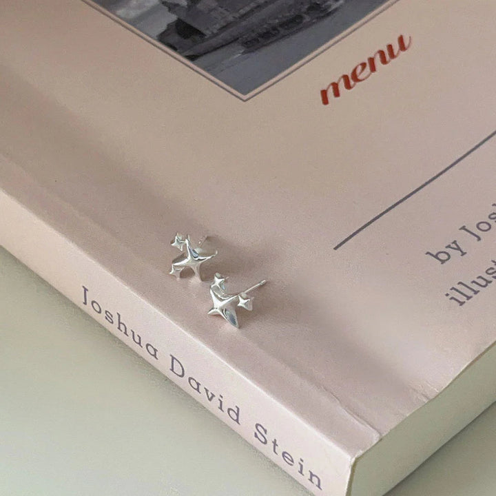 Shine bright like a diamond (or, you know, a star!) with our Star Emoji Cluster Studs | Sterling Silver! These adorable studs feature a cluster of tiny star emojis, perfect for adding a touch of playful charm to your look. Crafted in sterling silver, they're both stylish and durable. Lightweight and comfortable, they're perfect for everyday wear or a sweet gift for a friend. Reach for the stars! 