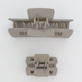 Two beige hair clamps on a white background