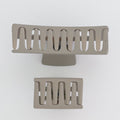 Two metallic hair clips on a white background