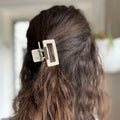 Close-up of a hair clip in a person's hair with a blurred background