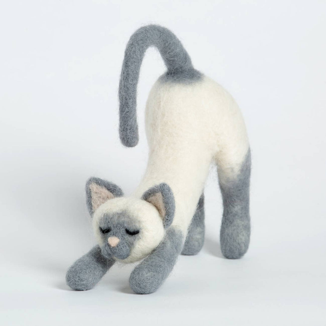 Plush toy cat with gray and white fur on a light gray background