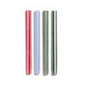 Set of four colorful striped candles on a white background