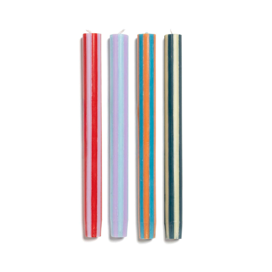 Set of four colorful striped candles on a white background