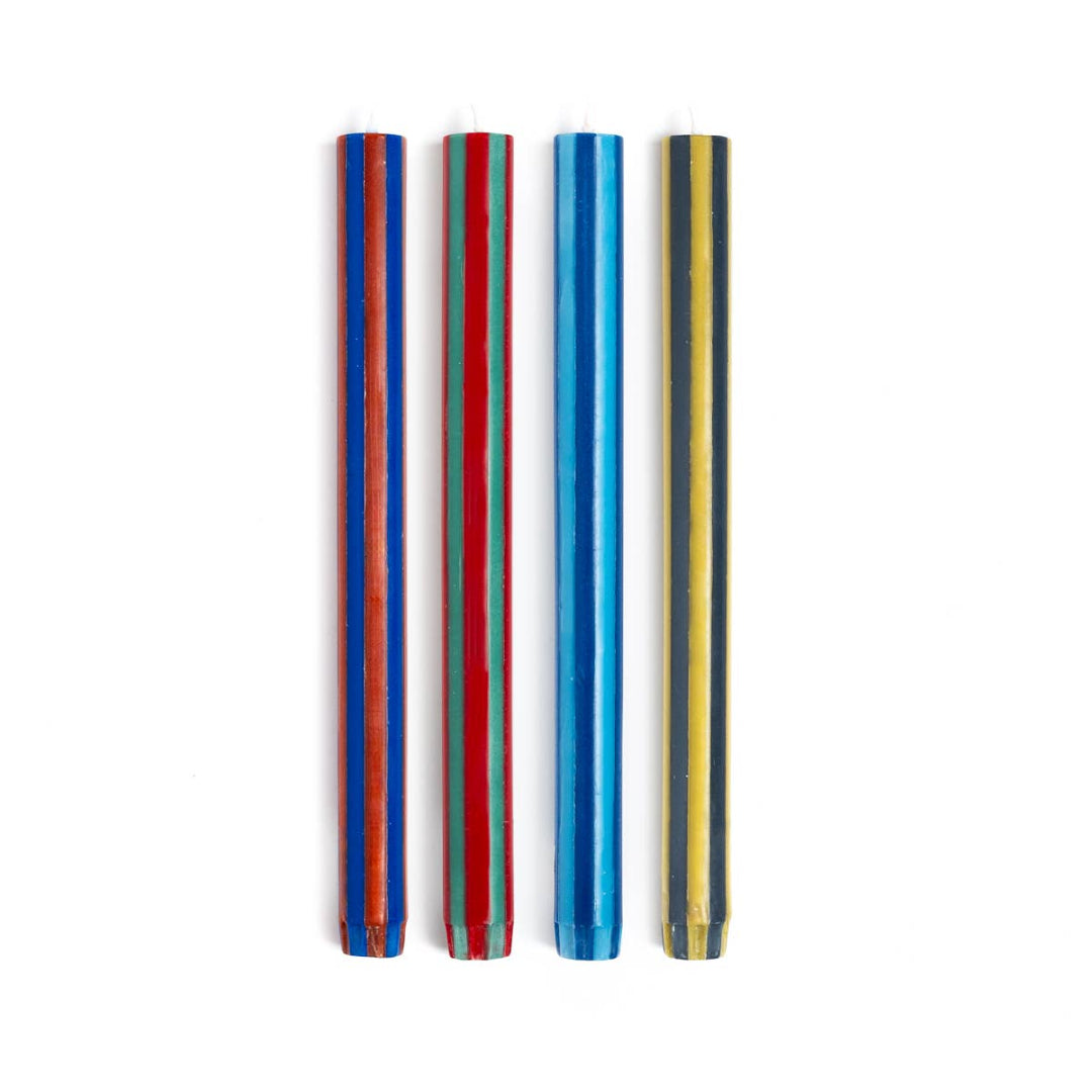 Two sets of colorful striped candles on a white background