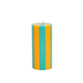 Striped teal and yellow candle on a white background