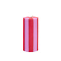 Striped red and pink candle on a white background