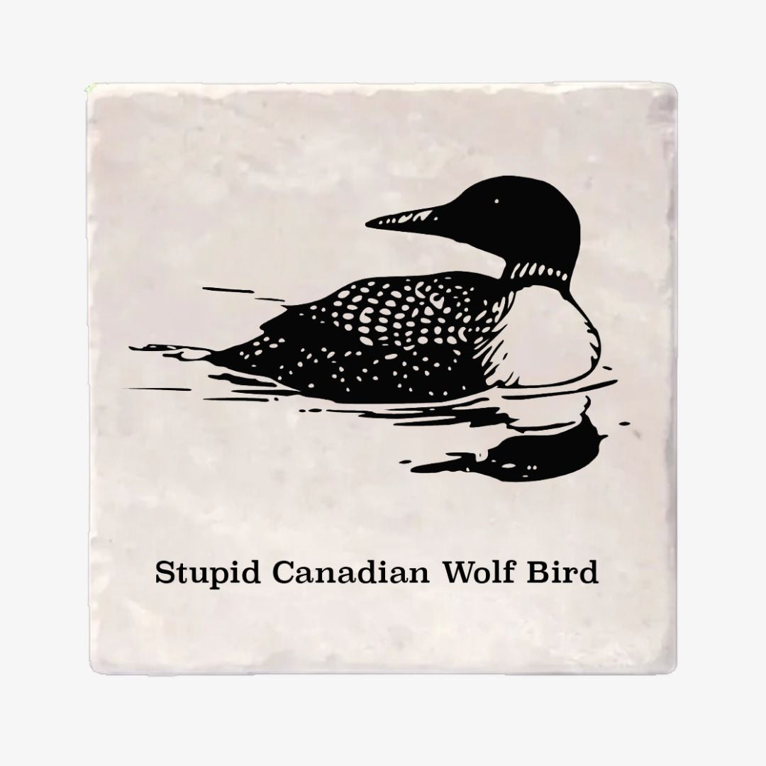 A square stone coaster featuring a black ink-style illustration of a loon duck and the text 'Stupid Canadian Wolf Bird' printed below, shown on a light gray background.