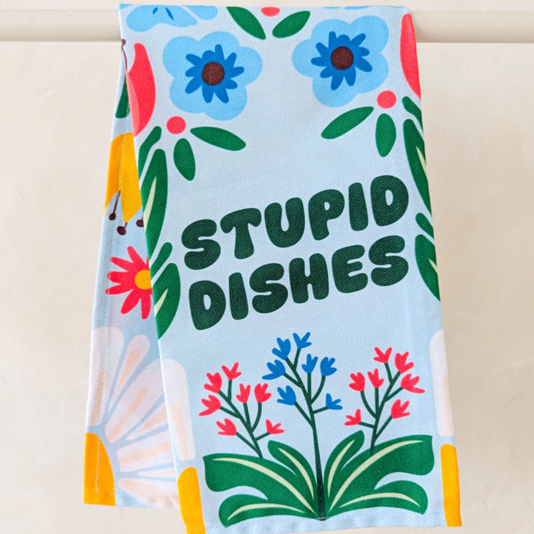 Floral-themed towel with 'STUPID DISHES' text on a light blue background