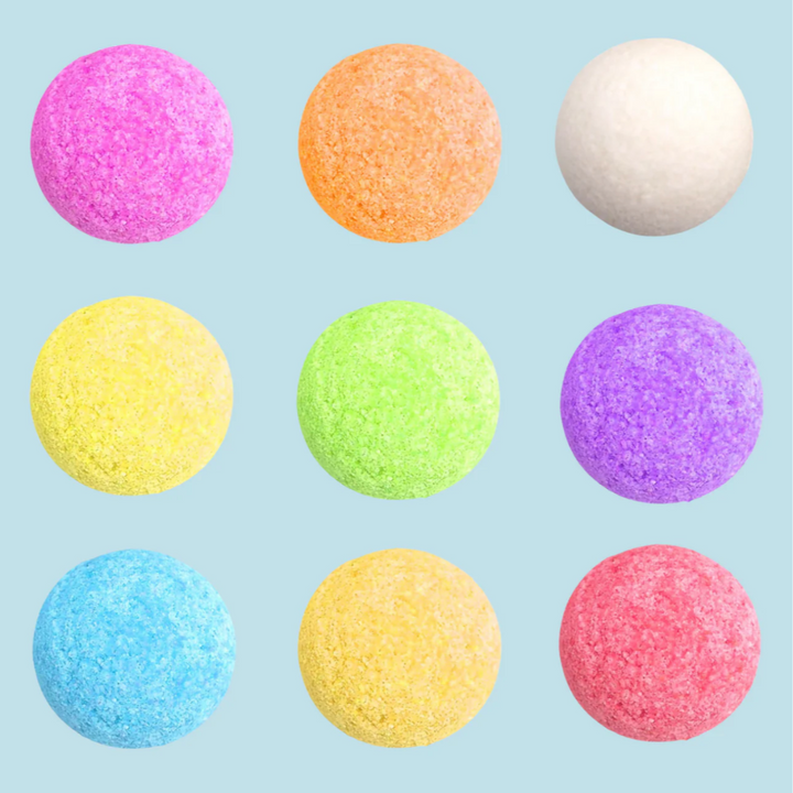 A Summer Cocktail Bomb Variety Pack, featuring colorful, fruit-flavored drink mixers in a white box, with a hand picking up a yellow cocktail bomb. The image includes strawberries, pineapples, and limes against a bright blue background. Available in Ottawa, Ontario, Canada.