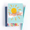 A congratulations card featuring a smiling sun with rays shining on clouds. The text 