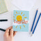A congratulations card featuring a smiling sun with rays shining on clouds. The text 