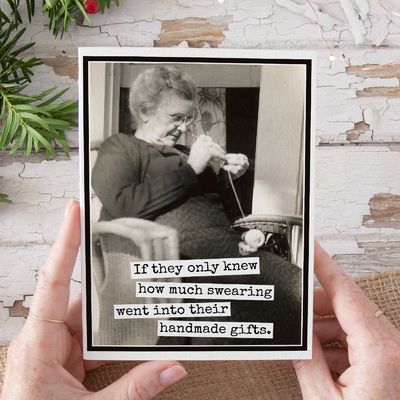 Person holding a card with a black and white photo of an elderly woman knitting and humorous text.