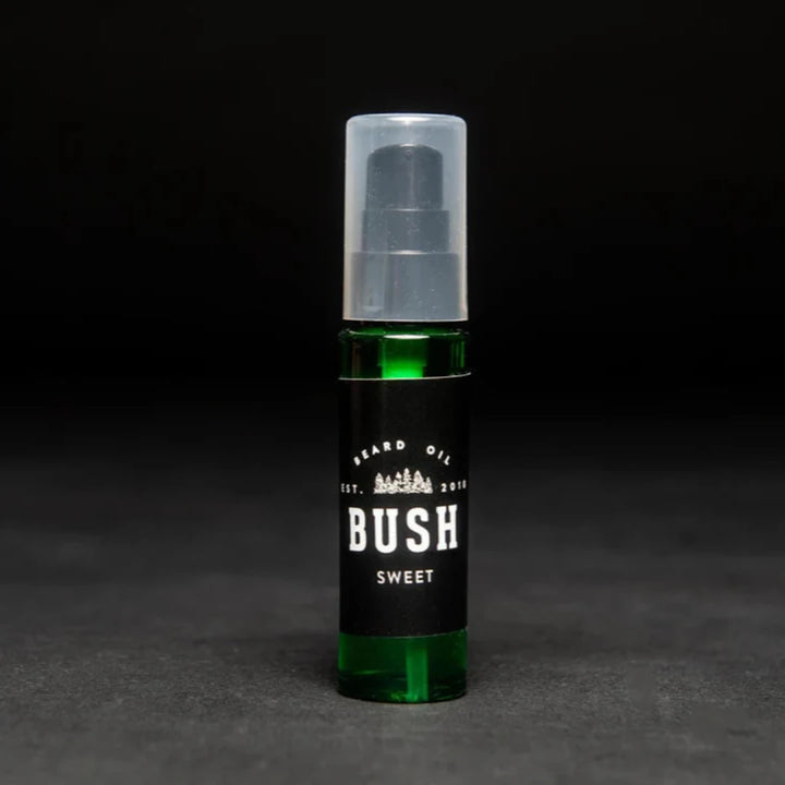 A dark green glass bottle with a black pump dispenser. The bottle is labeled 
