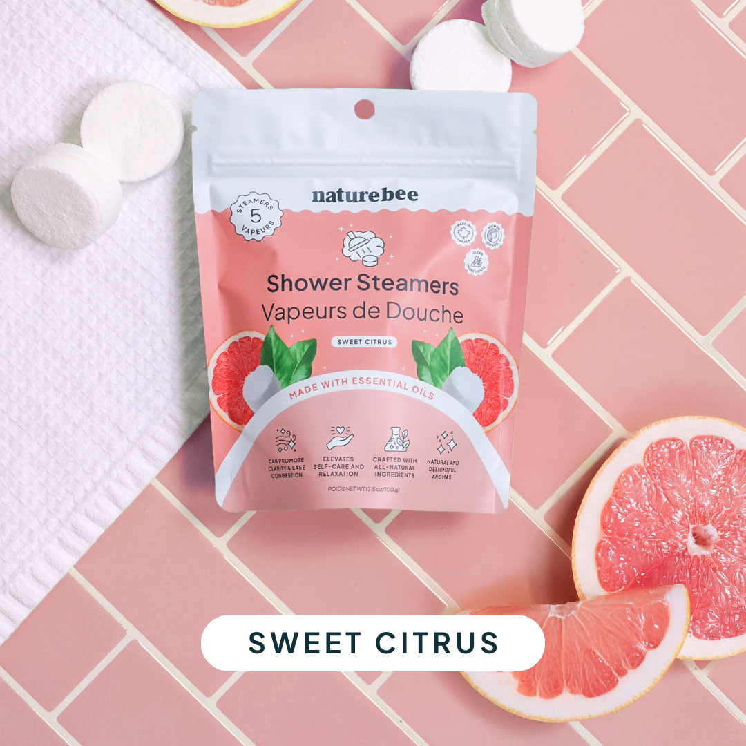 Package of naturebee shower steamers with grapefruit slices on a pink tiled background