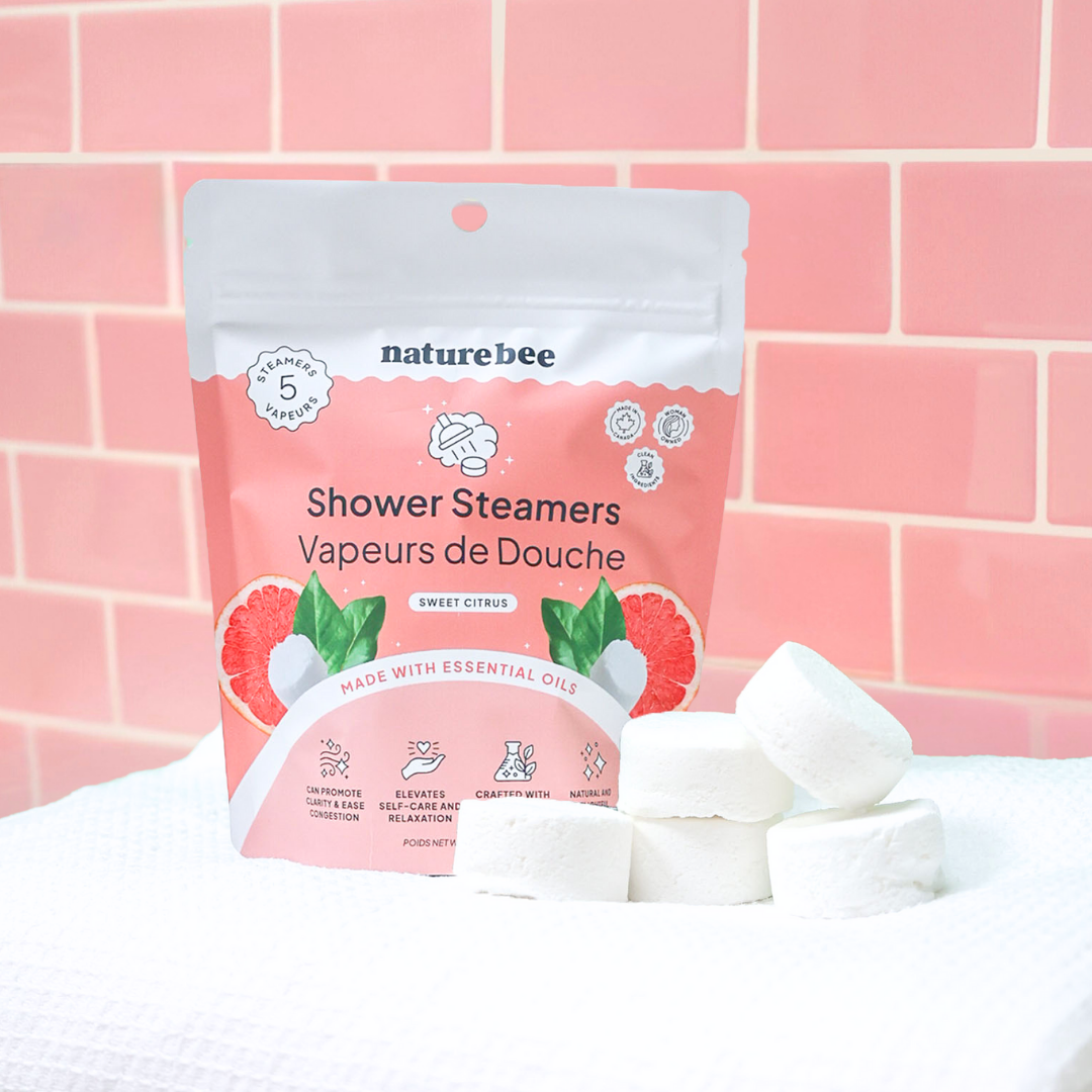 Naturebee shower steamers with packaging on a pink tiled background