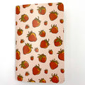 Notebook with strawberry pattern on a light pink background