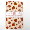 Notebook with strawberry pattern and Cara Bara branding on a white background