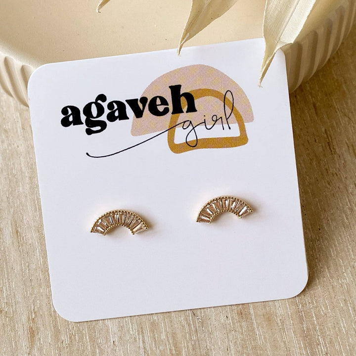 A pair of gold-plated stud earrings with a semicircle design. The earrings are adorned with multiple small cubic zirconia stones arranged in a fan shape.