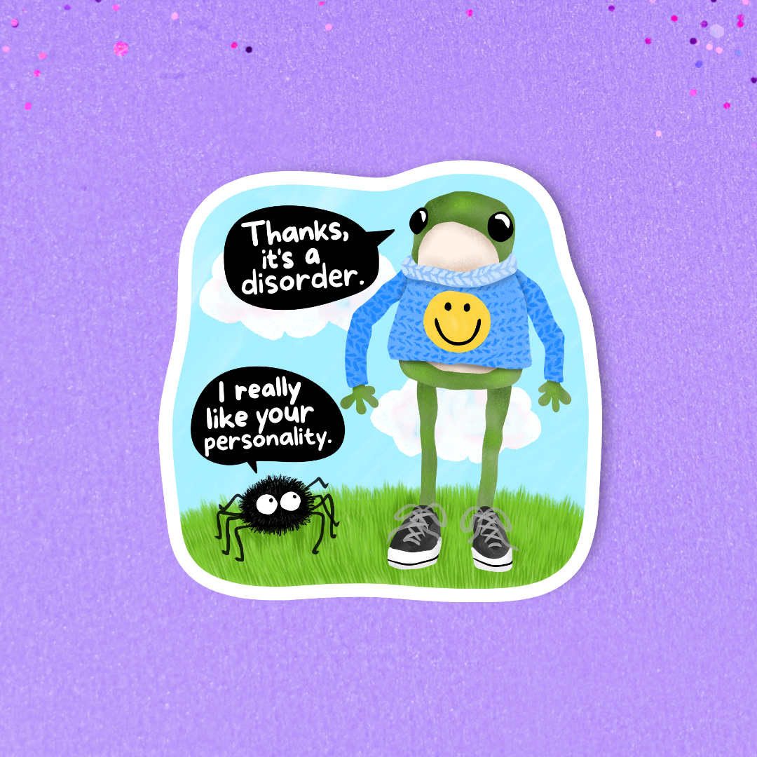 A die-cut sticker featuring a cartoon frog in a blue sweater with a yellow smiley face, standing on grass with speech bubbles that read 'Thanks, it's a disorder.' and 'I really like your personality.