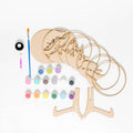 Wooden coasters with decorative designs, paint bottles, and a brush on a white background