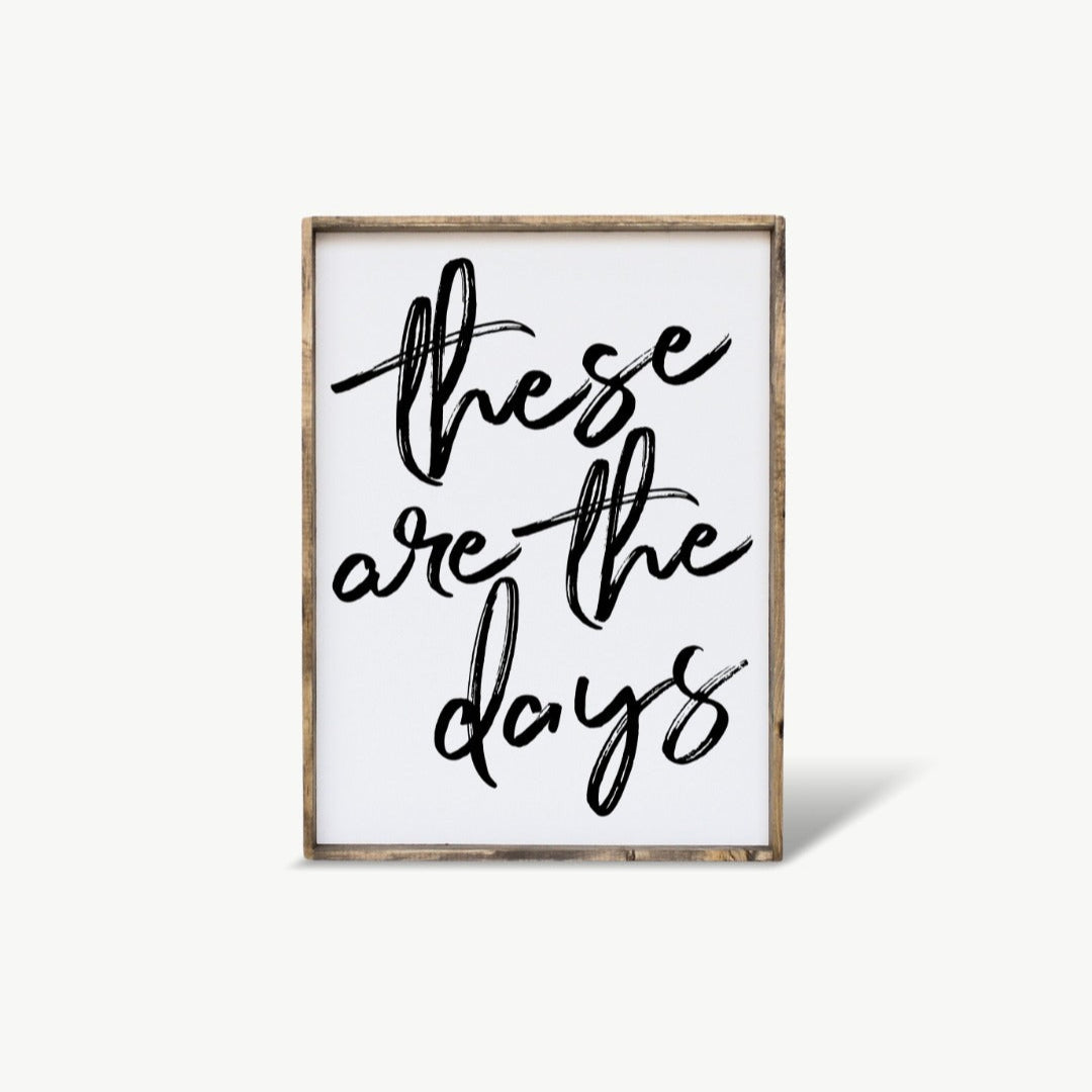 Framed artwork with 'these are the days' text on a white background