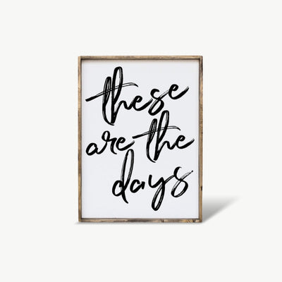 Framed artwork with 'these are the days' text on a white background