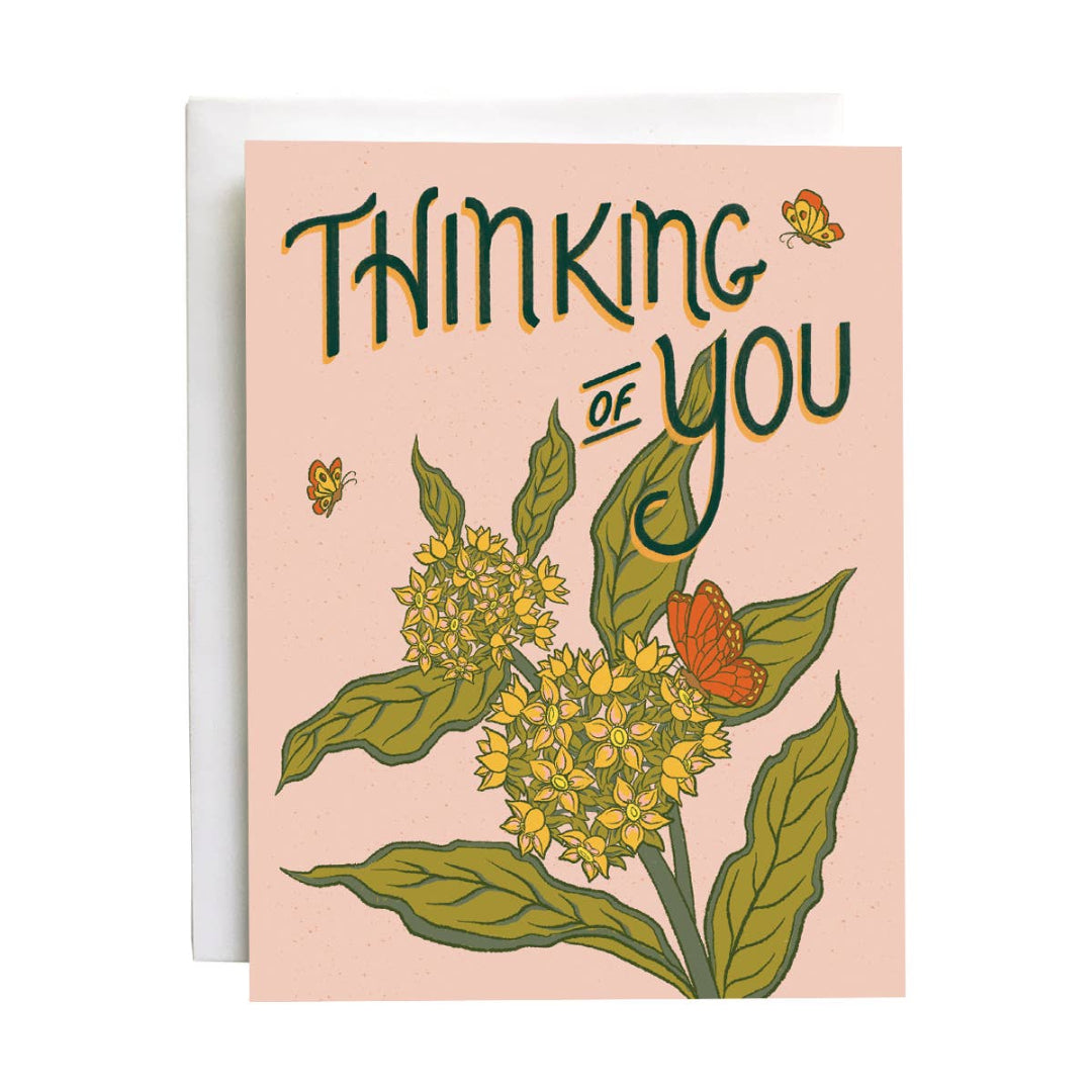 Greeting card with floral design and 'Thinking of You' text on a pink background