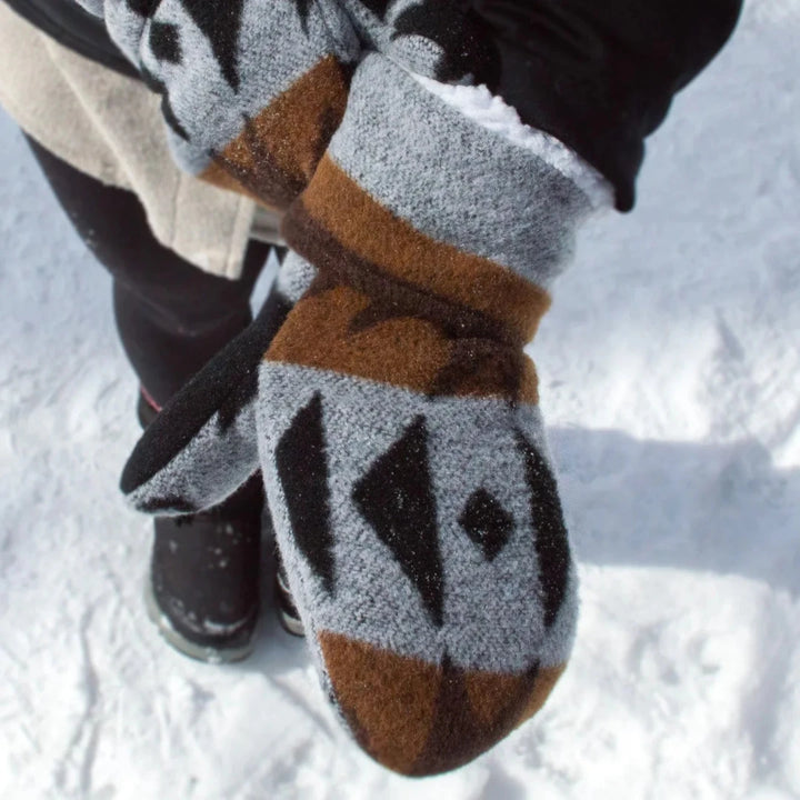 Thunderbird Mittens, indigenous designed with a black, grey and brown pattern. The mittens have an outer layer of wool and inner layer of sherpa.