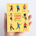 A card with a yellow background featuring seven people of different ages and races dancing. The text "TIME FOR A HAPPY DANCE YOU DID IT!" is written in bold letters below the figures.