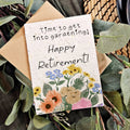 Greeting card with floral design and text 'Happy Retirement!' on a background of greenery.