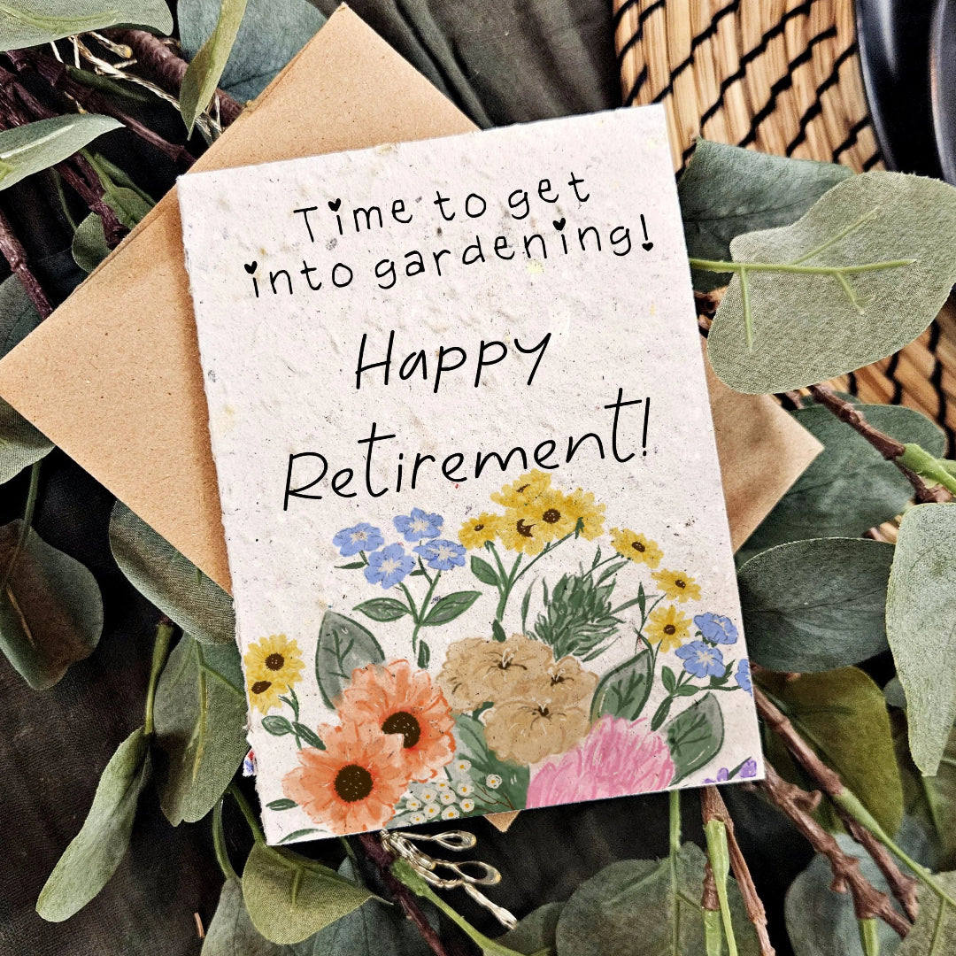 Greeting card with floral design and text 'Happy Retirement!' on a background of greenery.