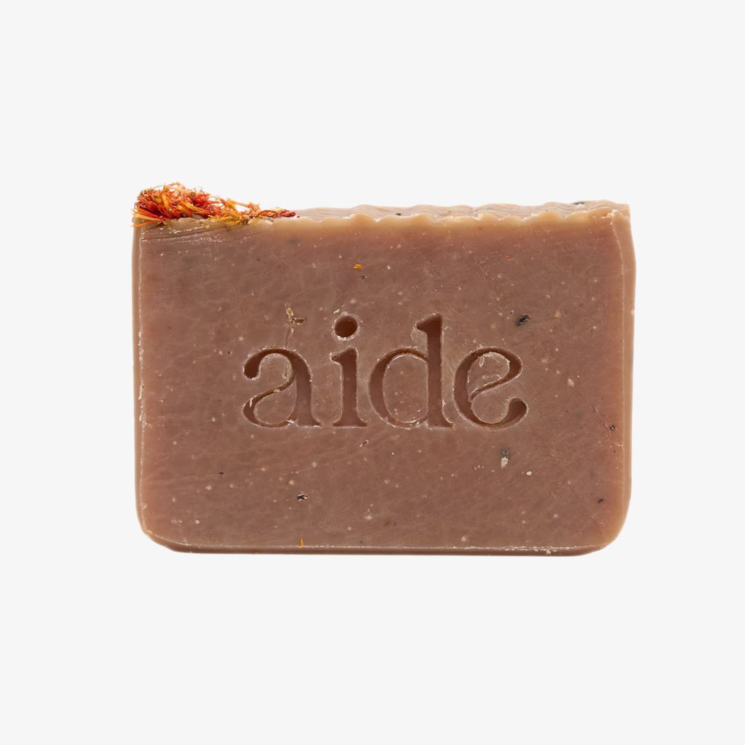 Bar of soap with 'aide' branding on a white background
