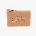Bar of soap with 'aide' branding on a light background