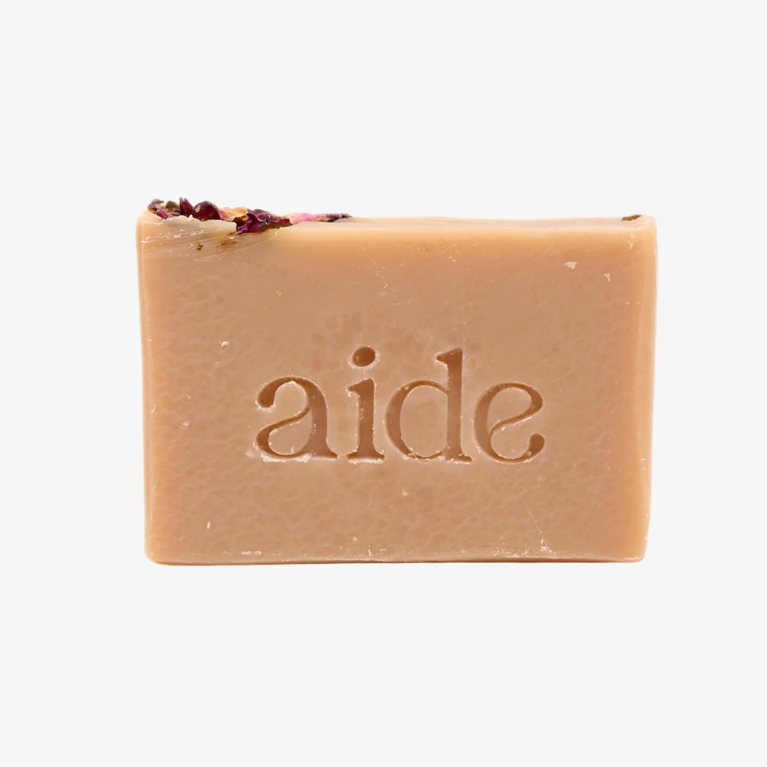 Bar of soap with 'aide' branding on a light background