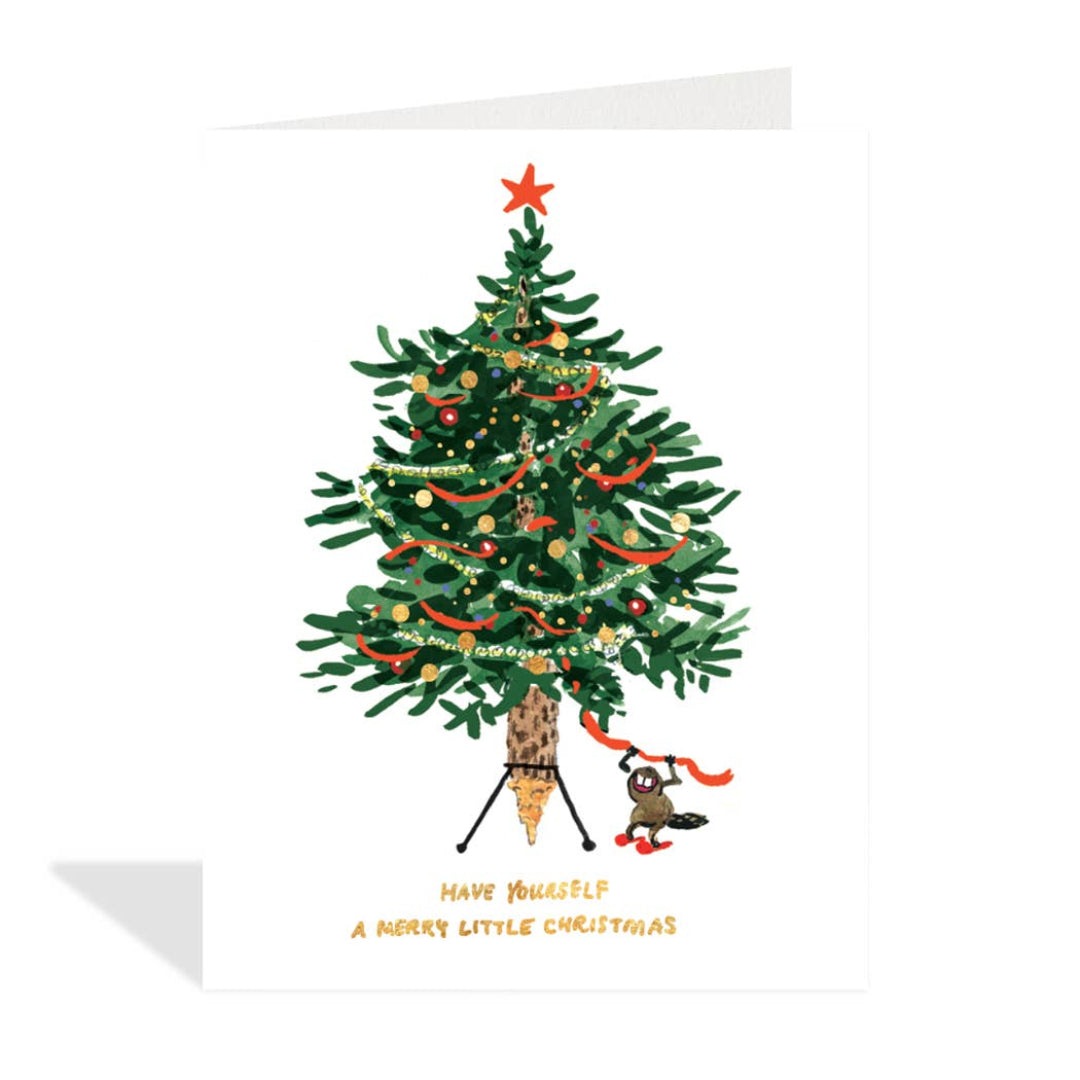Decorated Christmas tree with ornaments and a small figure underneath on a white background