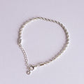 Silver bracelet on a light gray background