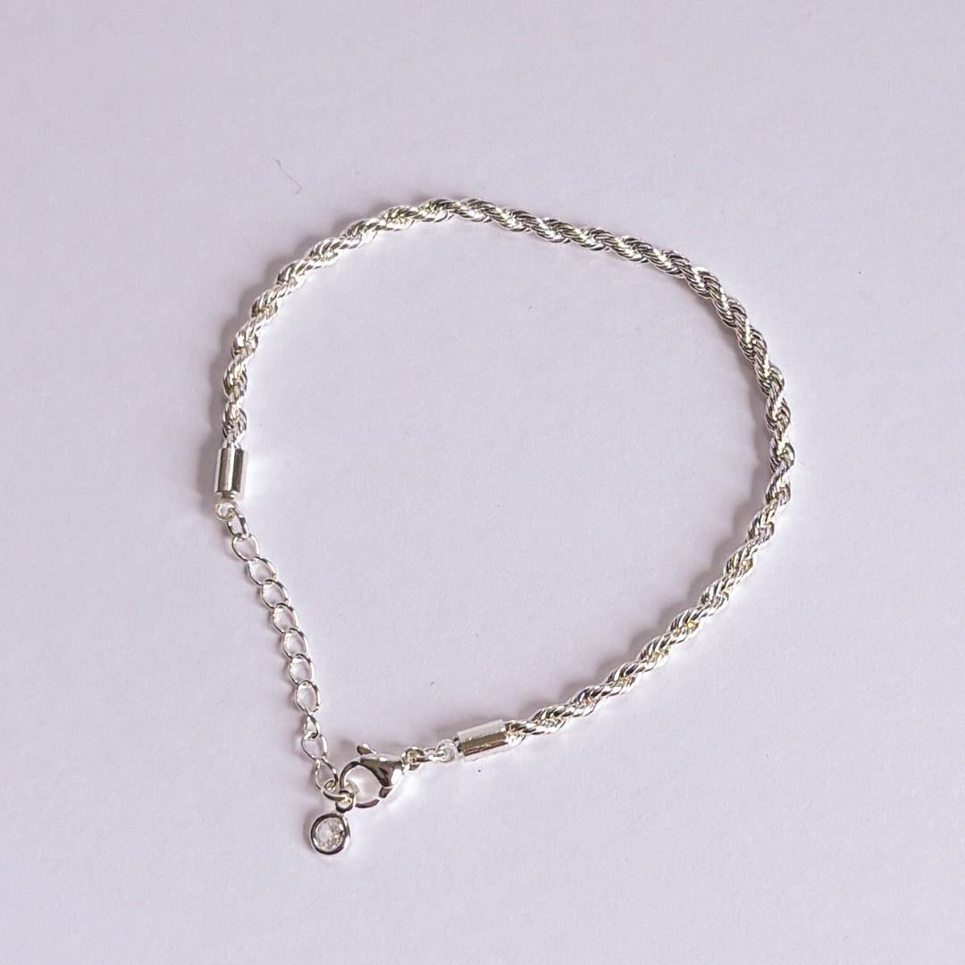 Silver bracelet on a light gray background