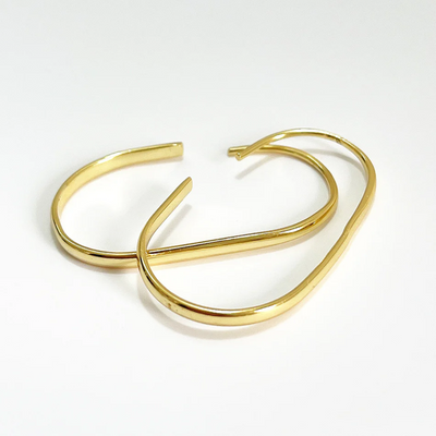 U-shaped open hoop earrings made with 18k gold plating, featuring a modern, minimalist, and open curved design, displayed on a white background. These unique earrings are available in Ottawa, Ontario, Canada.