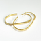 U-shaped open hoop earrings made with 18k gold plating, featuring a modern, minimalist, and open curved design, displayed on a white background. These unique earrings are available in Ottawa, Ontario, Canada.