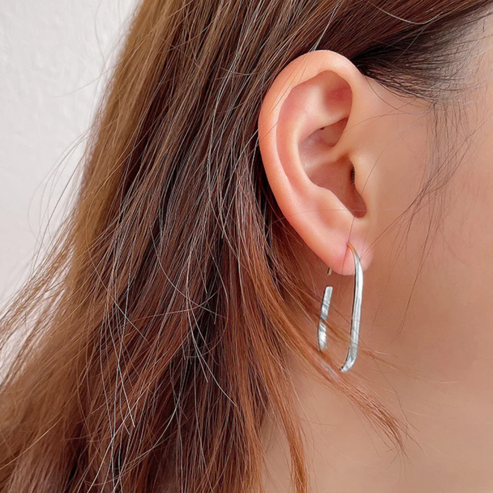 U-shaped open hoop earrings made with sterling silver plating, featuring a modern, minimalist, and open curved design, displayed on a white background. These unique earrings are available in Ottawa, Ontario, Canada