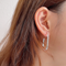 U-shaped open hoop earrings made with sterling silver plating, featuring a modern, minimalist, and open curved design, displayed on a white background. These unique earrings are available in Ottawa, Ontario, Canada